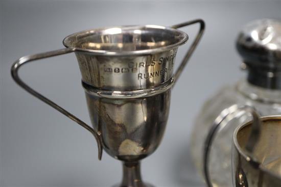 Five assorted small silver trophy cups, all with engraved inscriptions, tallest 12cm, and a silver mounted glass scent bottle.